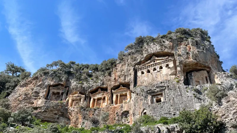 Kayalığın dibinden sıralanmış Dalyan kaya mezarları